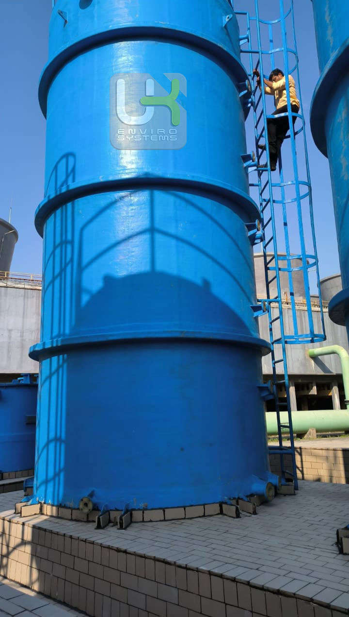 Installed chemical storage tank with technician on access ladder